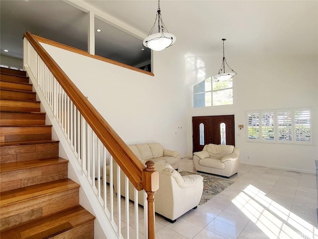 tiled entrance foyer with a high ceiling