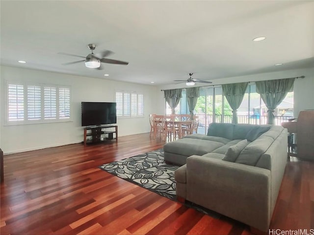 living room with ceiling fan, dark hardwood / wood-style flooring, and a wealth of natural light