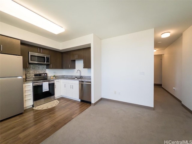 kitchen with dark brown cabinetry, stainless steel appliances, and sink