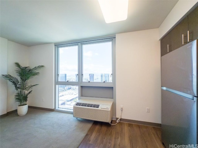 misc room with floor to ceiling windows and a wall unit AC