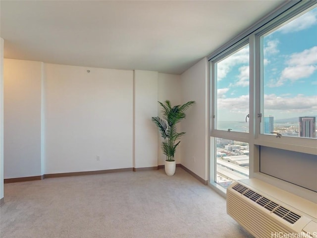 carpeted spare room with a water view and a wall mounted AC