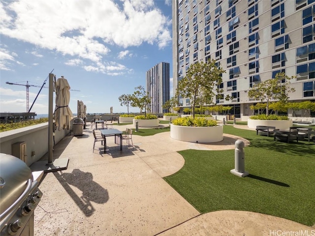 view of home's community with a lawn and a patio area