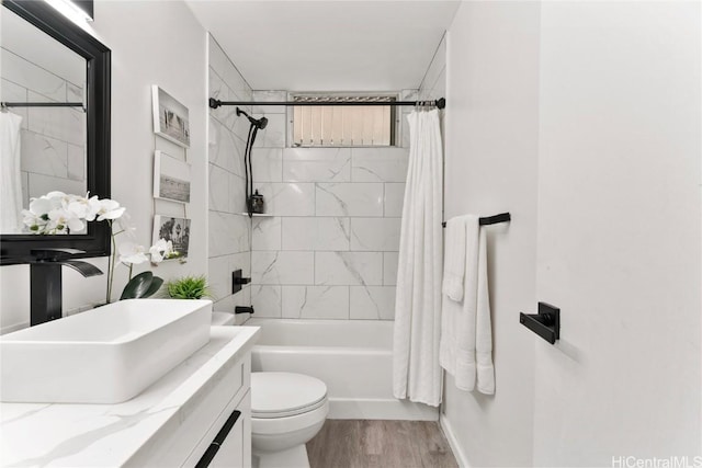 full bathroom featuring shower / tub combo, vanity, toilet, and hardwood / wood-style floors