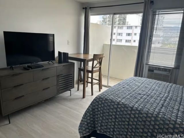 bedroom featuring cooling unit and light wood-type flooring