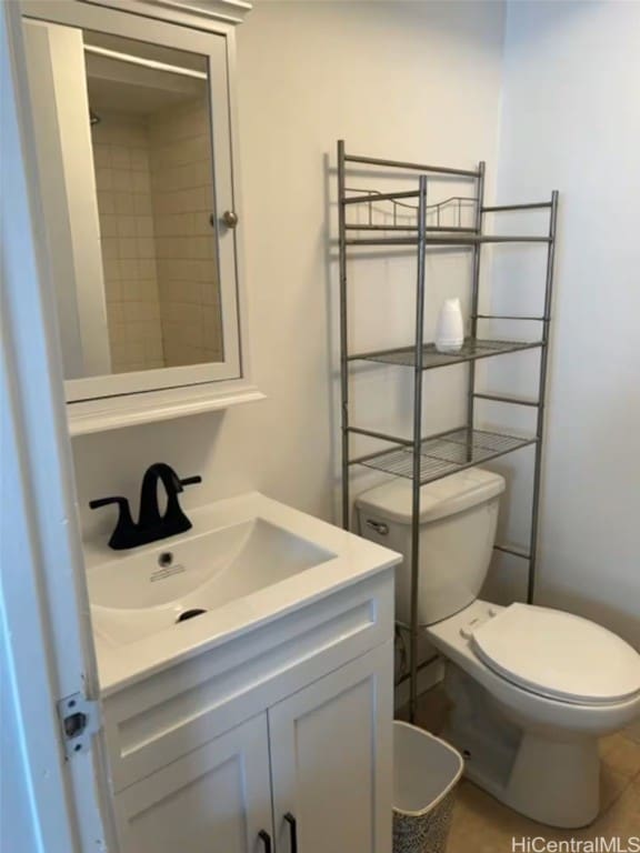 bathroom featuring vanity, tile patterned floors, and toilet