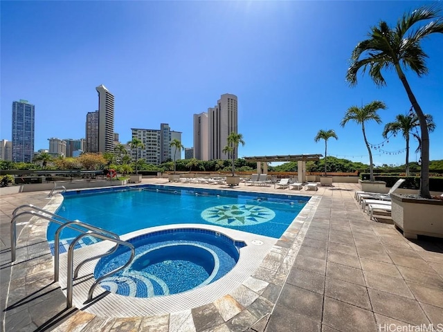 view of swimming pool with a community hot tub, a pergola, and a patio area