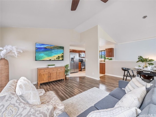 living room featuring dark hardwood / wood-style flooring, lofted ceiling, and ceiling fan