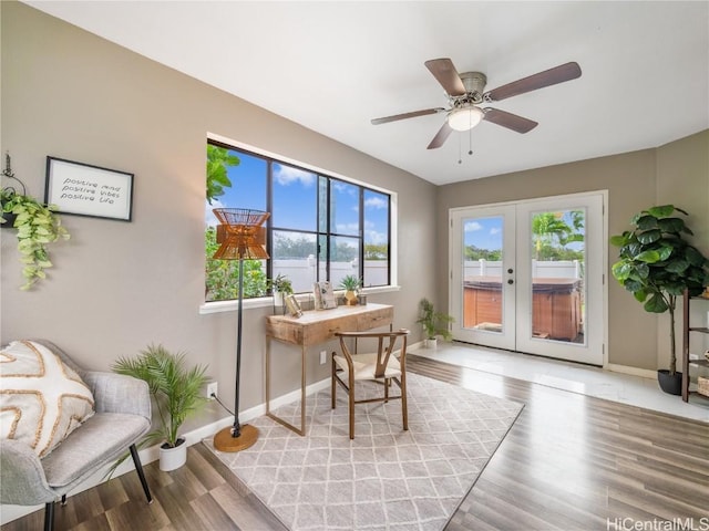 office area featuring ceiling fan, light wood-type flooring, and french doors