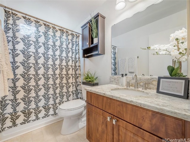 bathroom with tile patterned flooring, vanity, a shower with shower curtain, and toilet