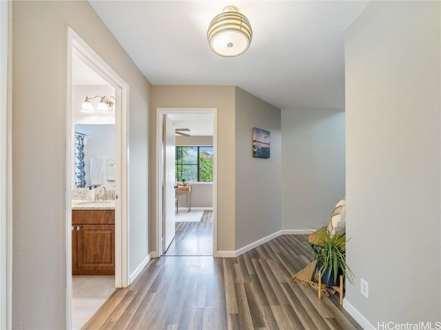 hall with sink and light hardwood / wood-style floors