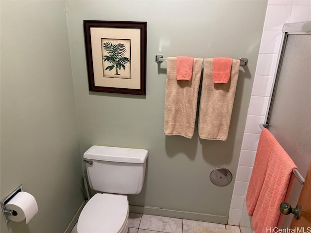 bathroom with a shower with shower door and toilet