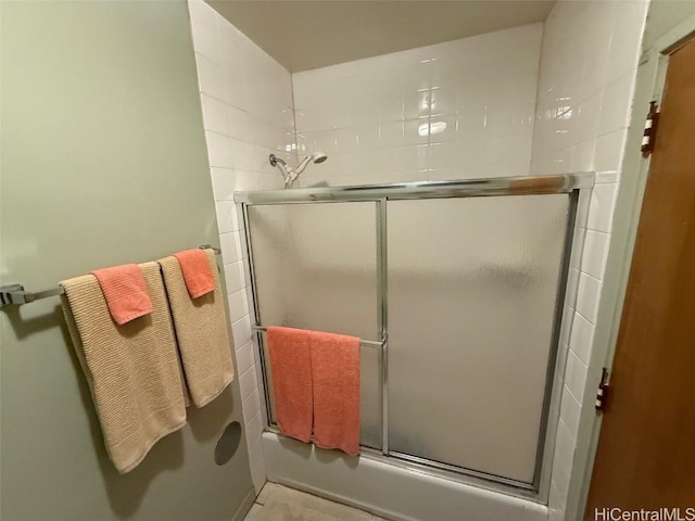 bathroom featuring shower / bath combination with glass door