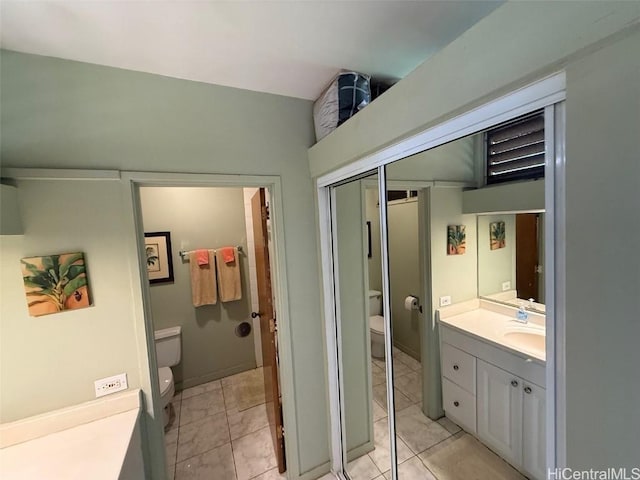 bathroom with vanity, toilet, and tile patterned flooring