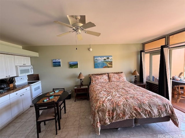 tiled bedroom featuring ceiling fan