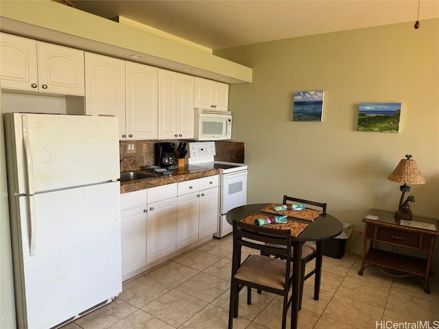 kitchen with white cabinetry, white appliances, and tasteful backsplash