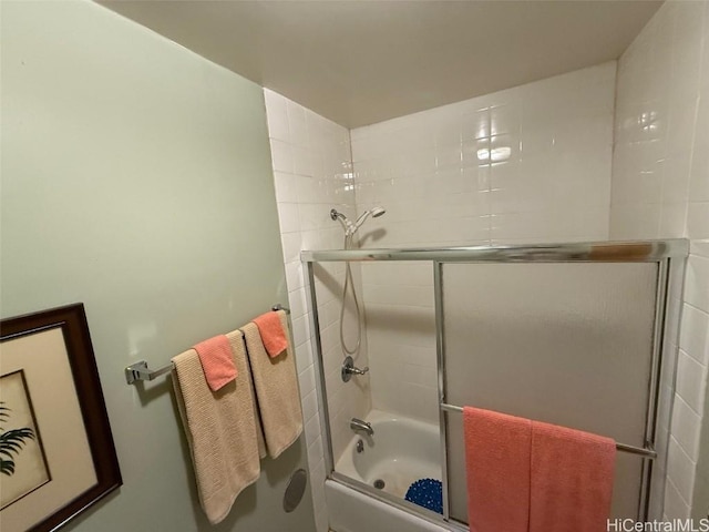 bathroom featuring bath / shower combo with glass door