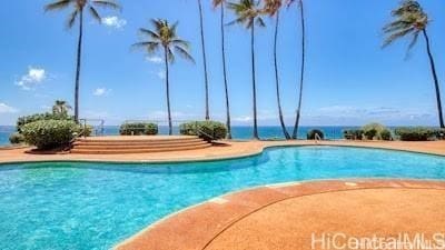 view of swimming pool with a water view