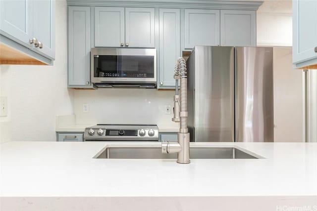 kitchen with sink and appliances with stainless steel finishes