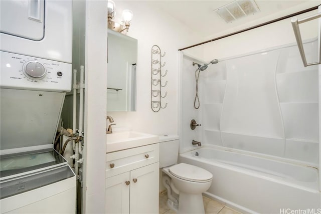 full bathroom featuring tile patterned floors, stacked washer / drying machine, toilet, tub / shower combination, and vanity