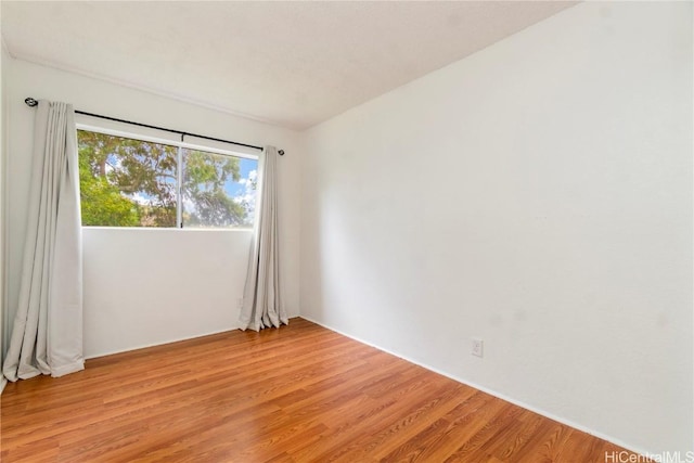 spare room with light hardwood / wood-style flooring