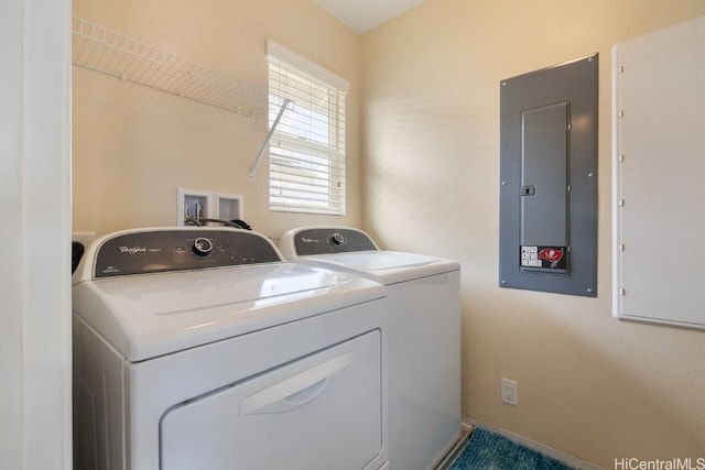 clothes washing area featuring electric panel and washer and dryer