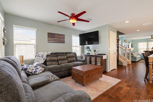 living room featuring dark wood-type flooring and ceiling fan