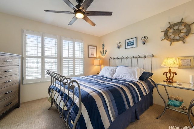 bedroom with ceiling fan and light carpet