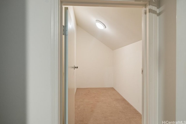 interior space featuring vaulted ceiling and carpet flooring