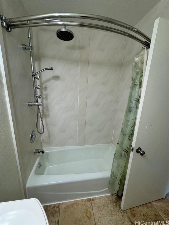 bathroom featuring tile patterned flooring and shower / bath combo with shower curtain