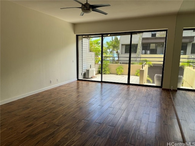 spare room with dark wood-type flooring and ceiling fan