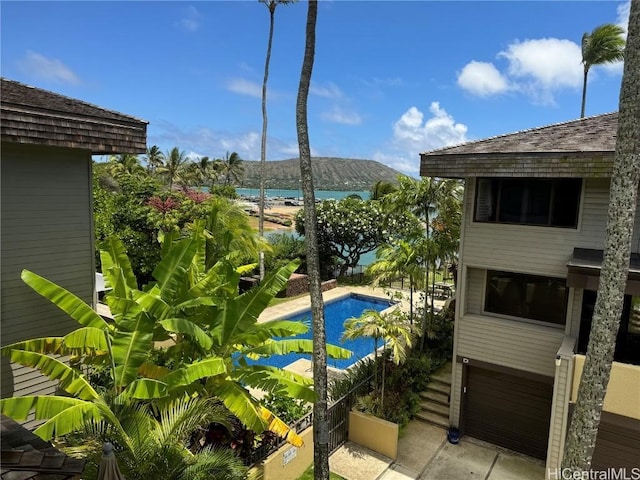 view of swimming pool featuring a water view