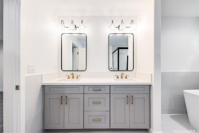 bathroom with tile walls, vanity, and a bathtub