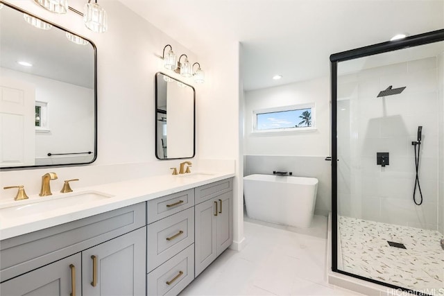 bathroom with vanity and independent shower and bath