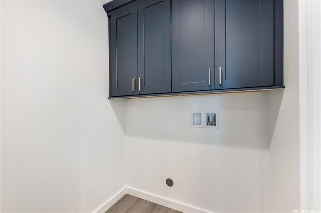 55-431 Iosepa St Unit D, Laie, HI 96762 - laundry area featuring baseboards, cabinet space, wood finished floors, and washer hookup