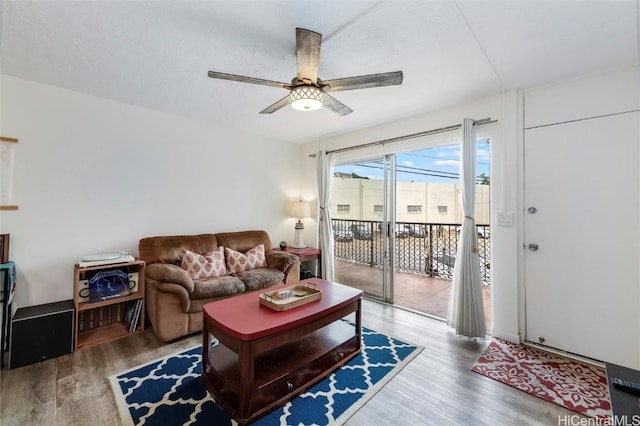 living room with hardwood / wood-style floors and ceiling fan