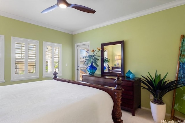 carpeted bedroom with ceiling fan and ornamental molding