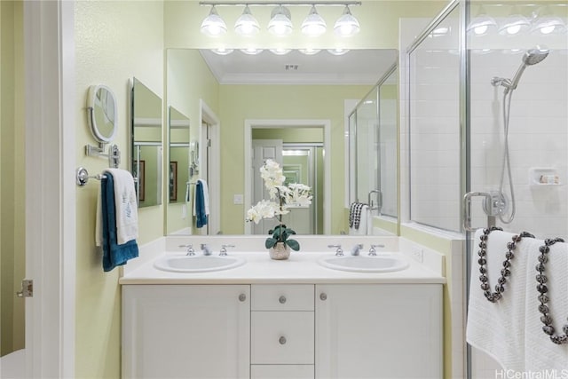 bathroom featuring vanity, crown molding, and a shower with door