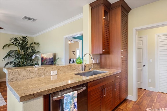 kitchen featuring sink, hardwood / wood-style flooring, stainless steel dishwasher, light stone counters, and kitchen peninsula