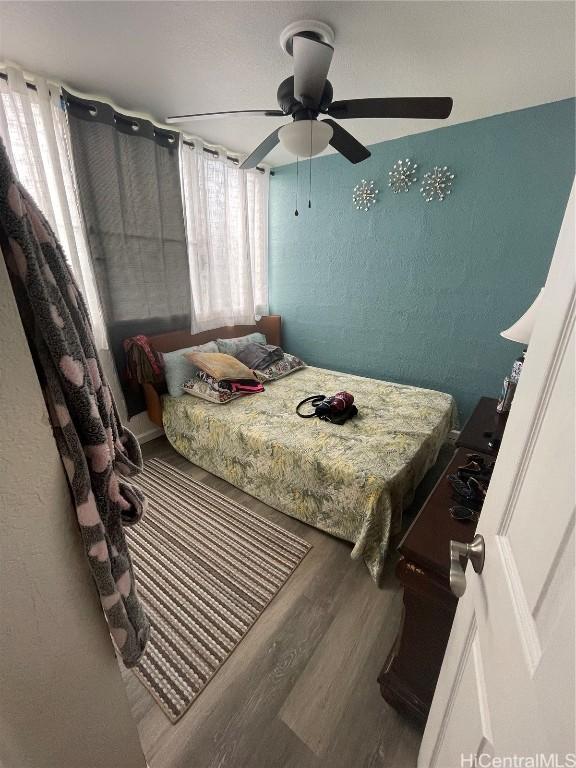 bedroom featuring hardwood / wood-style flooring and ceiling fan