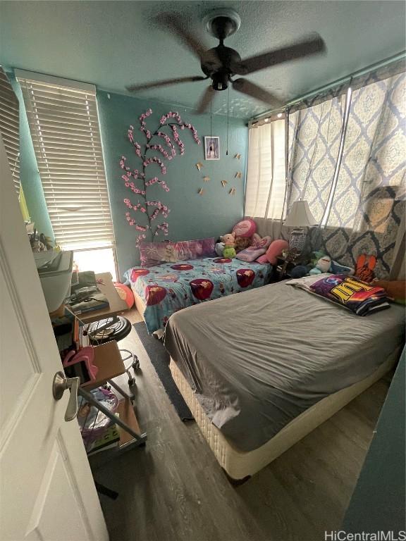 bedroom featuring hardwood / wood-style flooring and ceiling fan