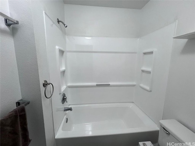 bathroom featuring toilet and shower / bath combination