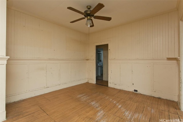 unfurnished room featuring ceiling fan, ornamental molding, and hardwood / wood-style floors