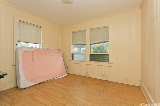 spare room with crown molding and wood-type flooring