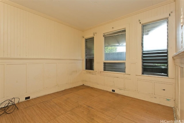 unfurnished room with light hardwood / wood-style flooring and ornamental molding