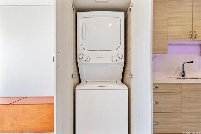 laundry area featuring stacked washer and clothes dryer