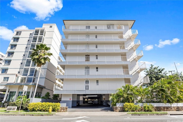 view of apartment building / complex featuring a carport