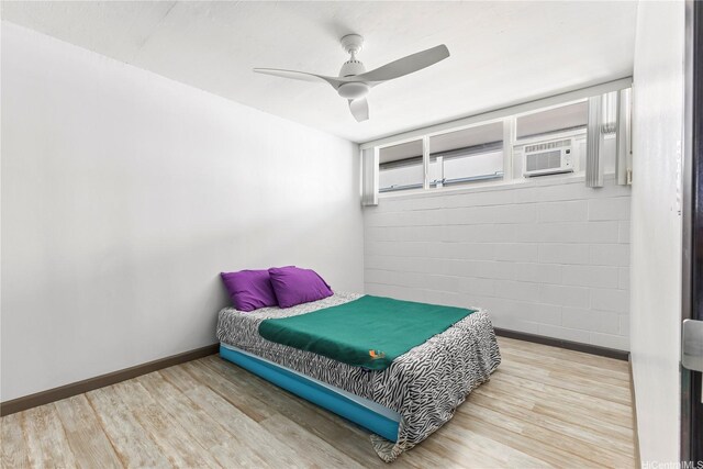 bedroom featuring wood finished floors, baseboards, and ceiling fan