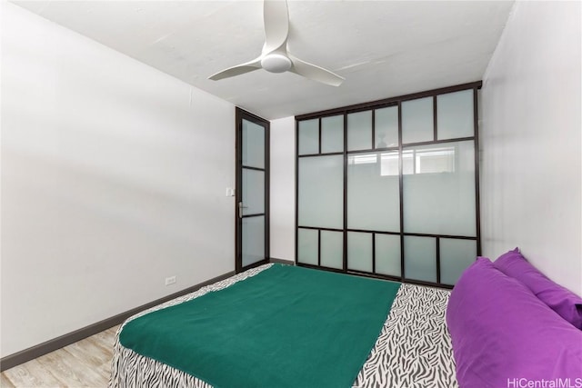 bedroom with light wood-type flooring and ceiling fan