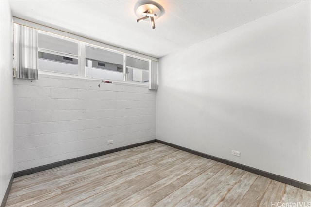 unfurnished room with light hardwood / wood-style flooring