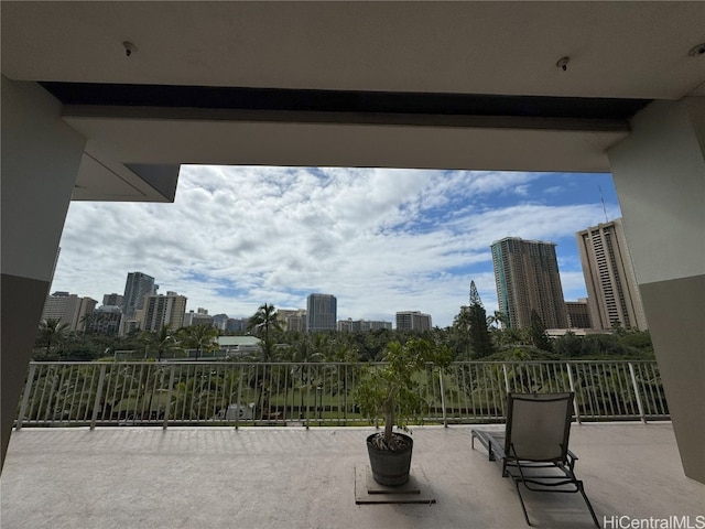 view of patio / terrace featuring a balcony and a city view